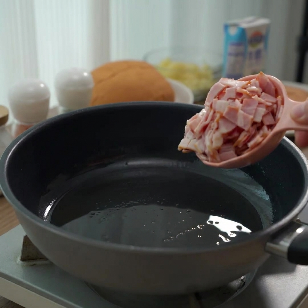 Raw chopped bacon pieces being poured from a pink measuring cup into a frying pan.