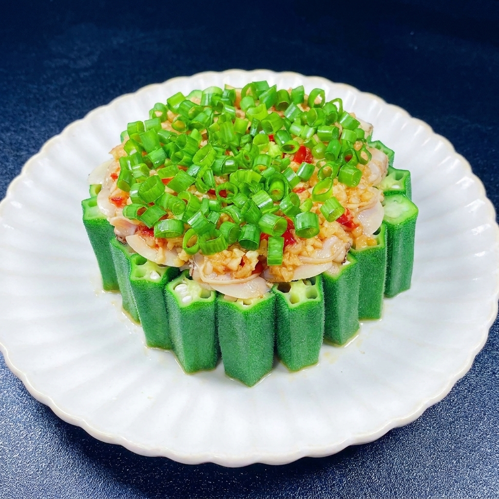 A generous pile of bright green chopped scallions sitting on top of the minced garlic and clam meat inside the okra ring.