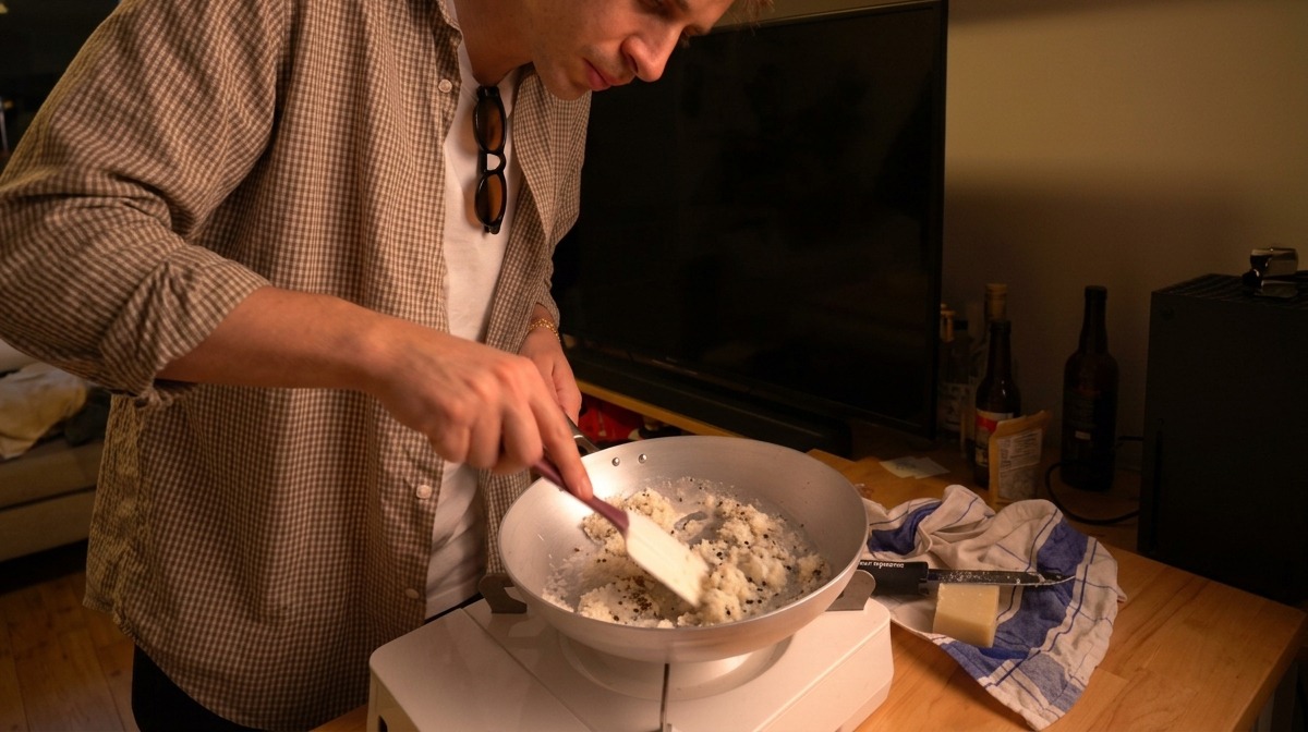 Stirring the Pecorino cheese, warm water, and black pepper together with a spatula to form a thick paste.