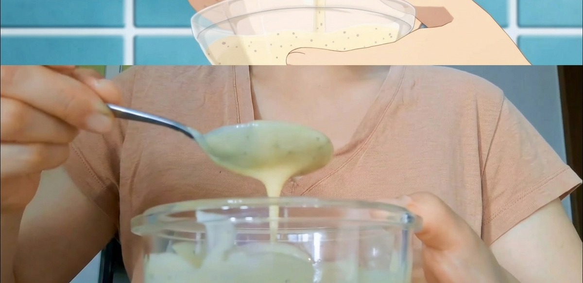 Hands stirring a creamy, speckled sandwich sauce in a clear glass bowl with a metal spoon.