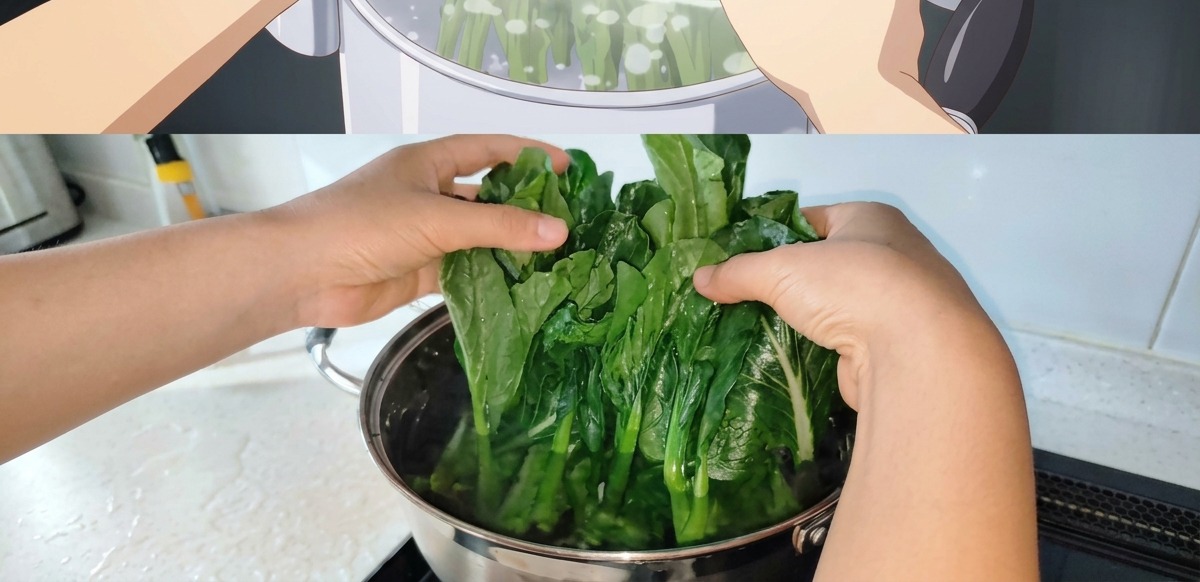 Hands carefully submerging a bunch of fresh spinach into boiling water, inserting the thick stems first.