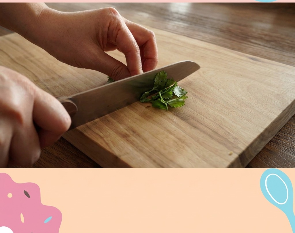 Hands using a chefs knife to finely mince a pile of vibrant green parsley leaves on a wooden board.