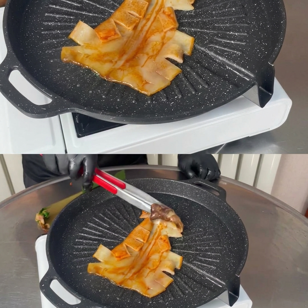 Metal tongs placing a whole marinated squid flat onto a hot, black ridged grill pan.