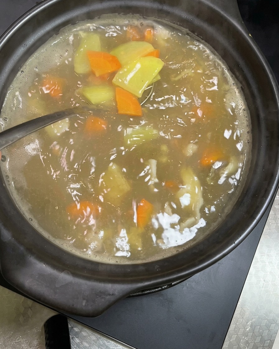Fresh, crisp soybean sprouts being dropped into the boiling vegetable and pork stew.