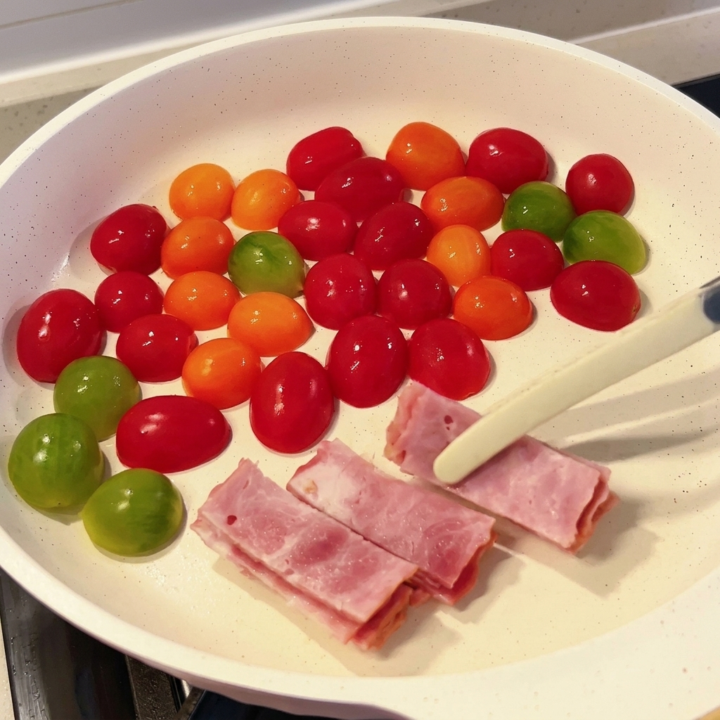 Slices of bacon being added to the skillet with tomatoes.