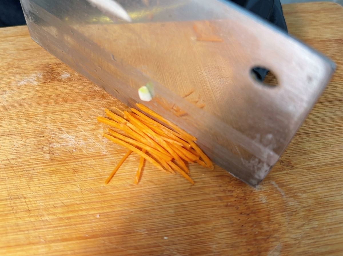 Thin matchstick strips of carrot prepared and ready for assembly.