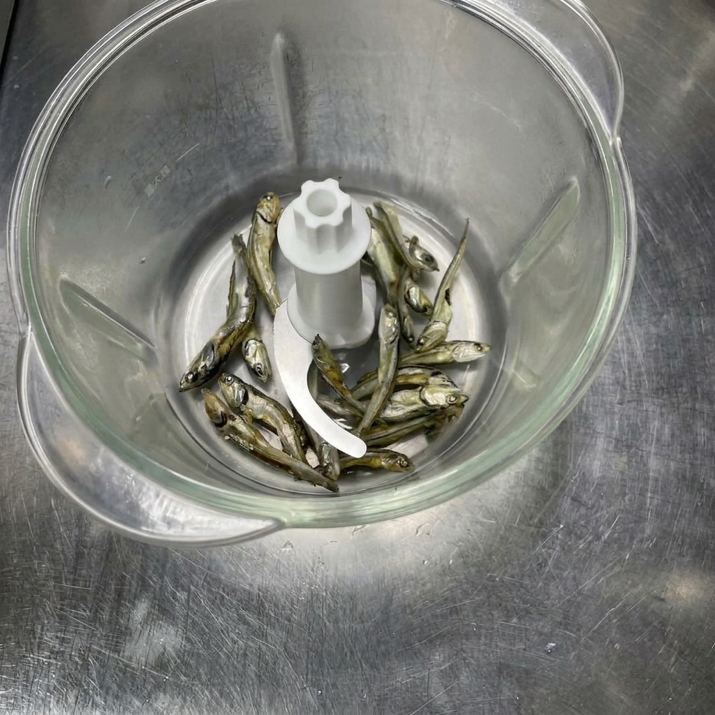 Dried fish ingredients inside a food processor before being ground into powder.