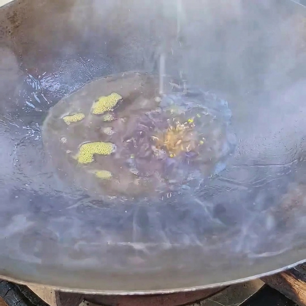 White sugar melting and turning into a dark caramel syrup in hot oil within a wok.