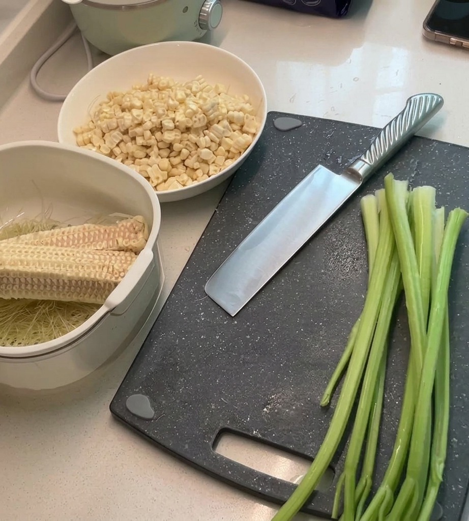 Fresh green celery stalks being diced on a cutting board.