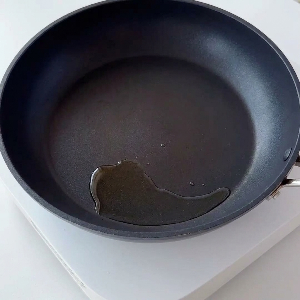 Egg-coated rice being stir-fried in a hot pan.
