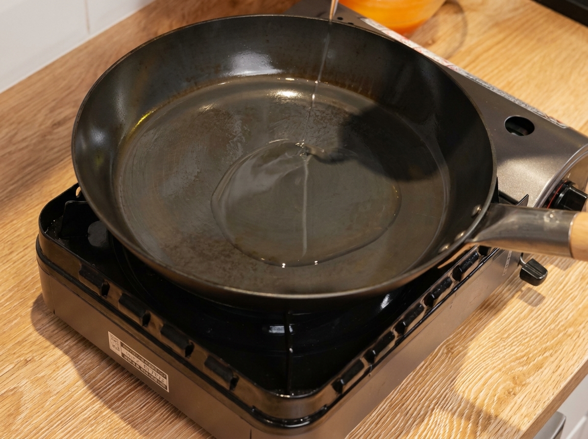 Soft scrambled eggs being cooked in a pan.