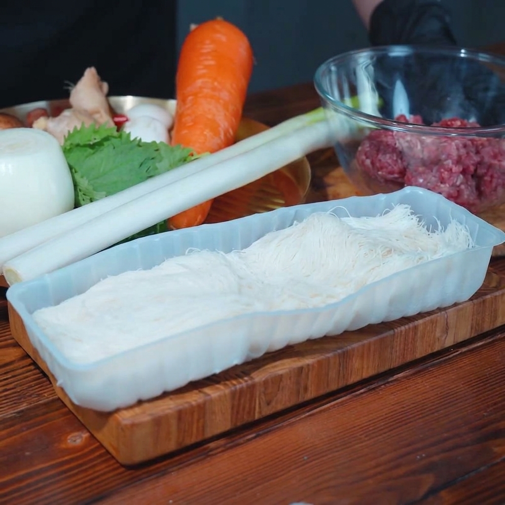 Fresh leek, shiitake mushrooms, and onion pieces on a wooden cutting board, ready for the filling.