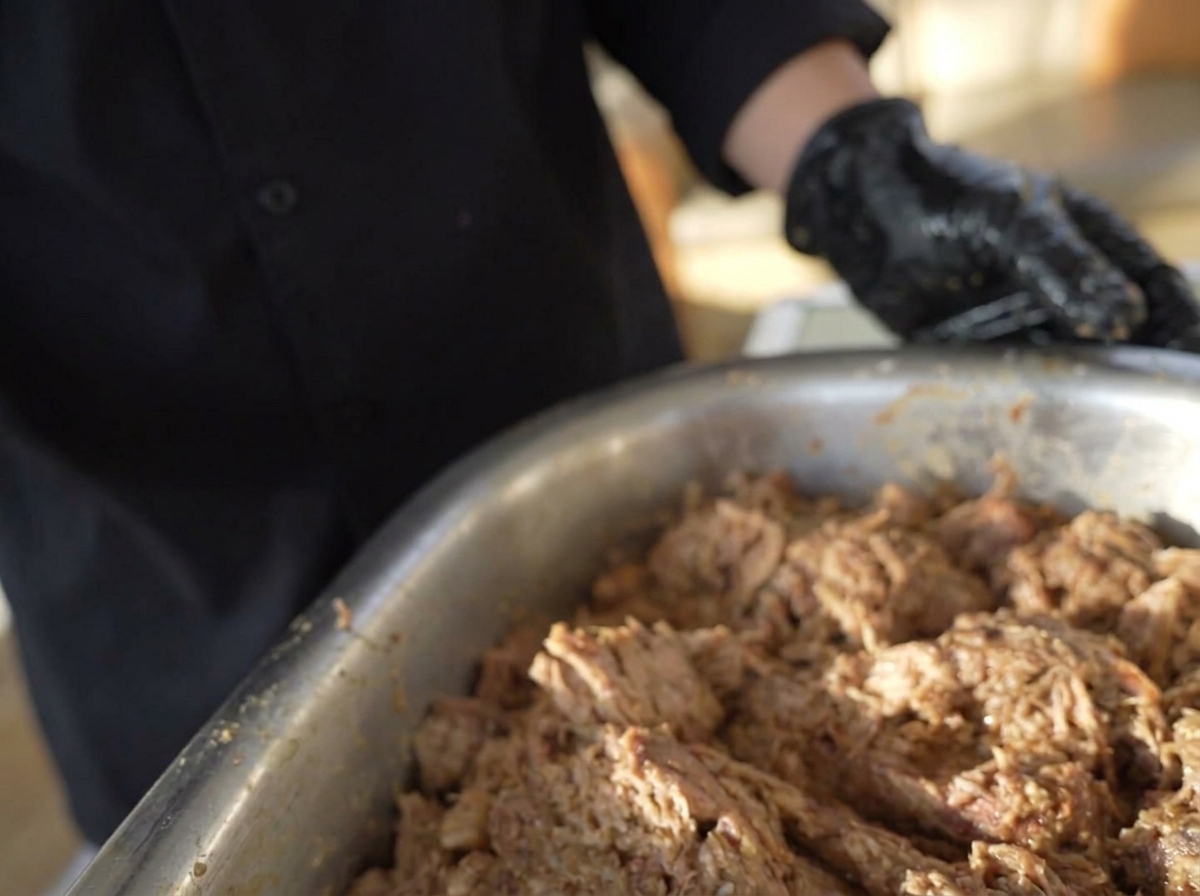 Hands shaping the marinated ground meat mixture into round, thick patties.