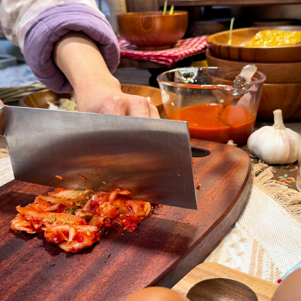 Soft white cubes of silken tofu being carefully placed into a simmering, spicy beef stew.