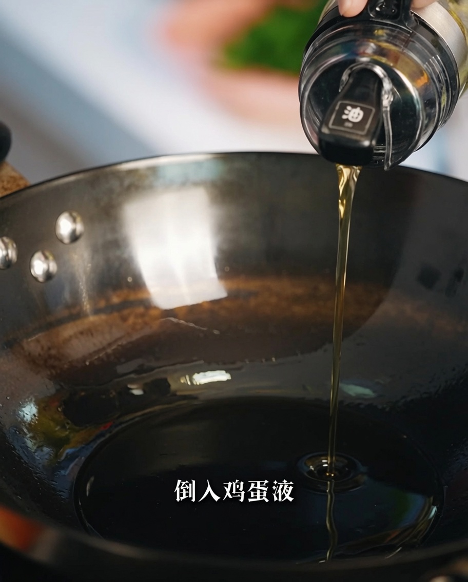 Beaten egg mixture being poured into a hot, oiled pan.