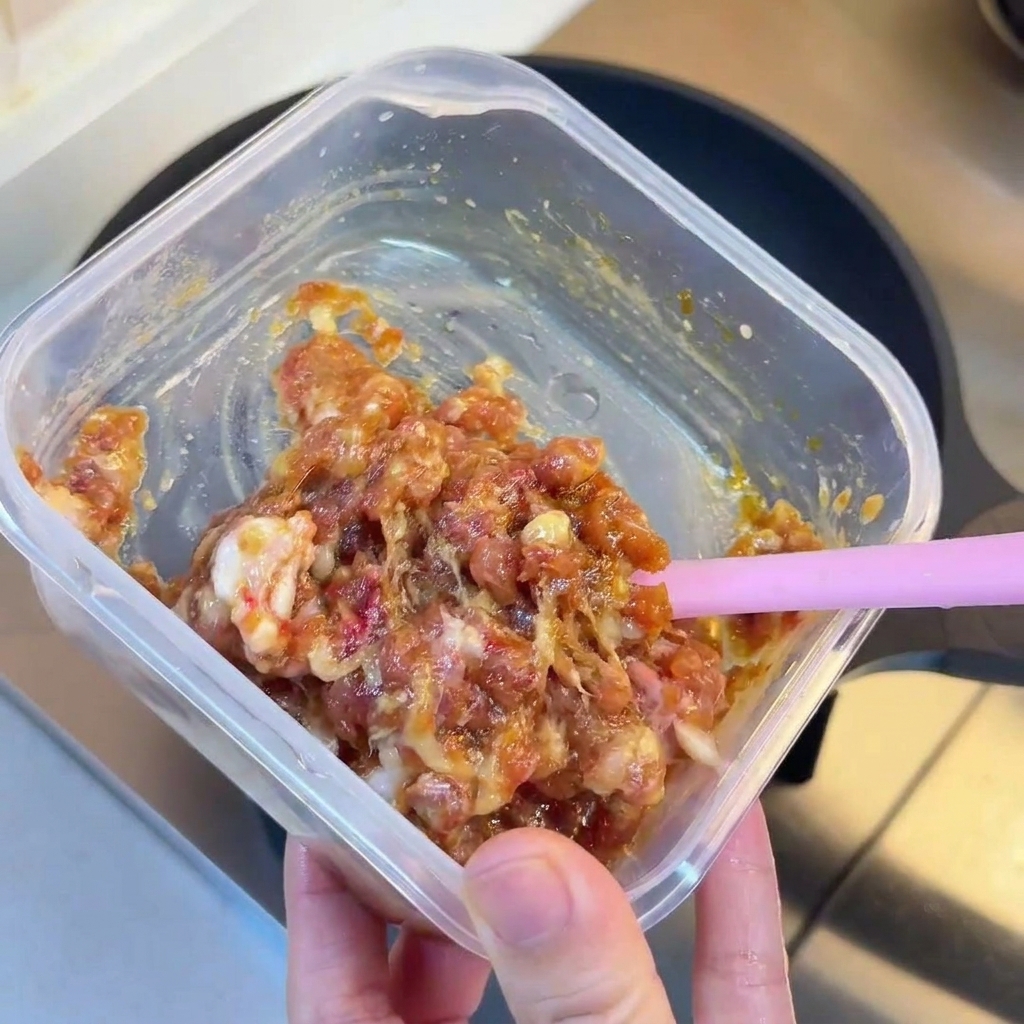 Minced meat browning in a hot frying pan.