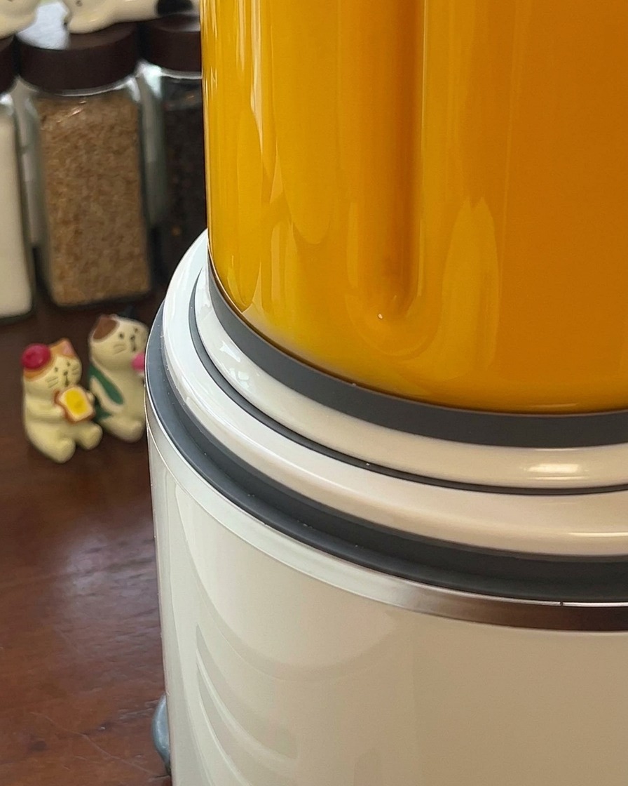 Smooth orange pumpkin soup being blended inside a high speed blender