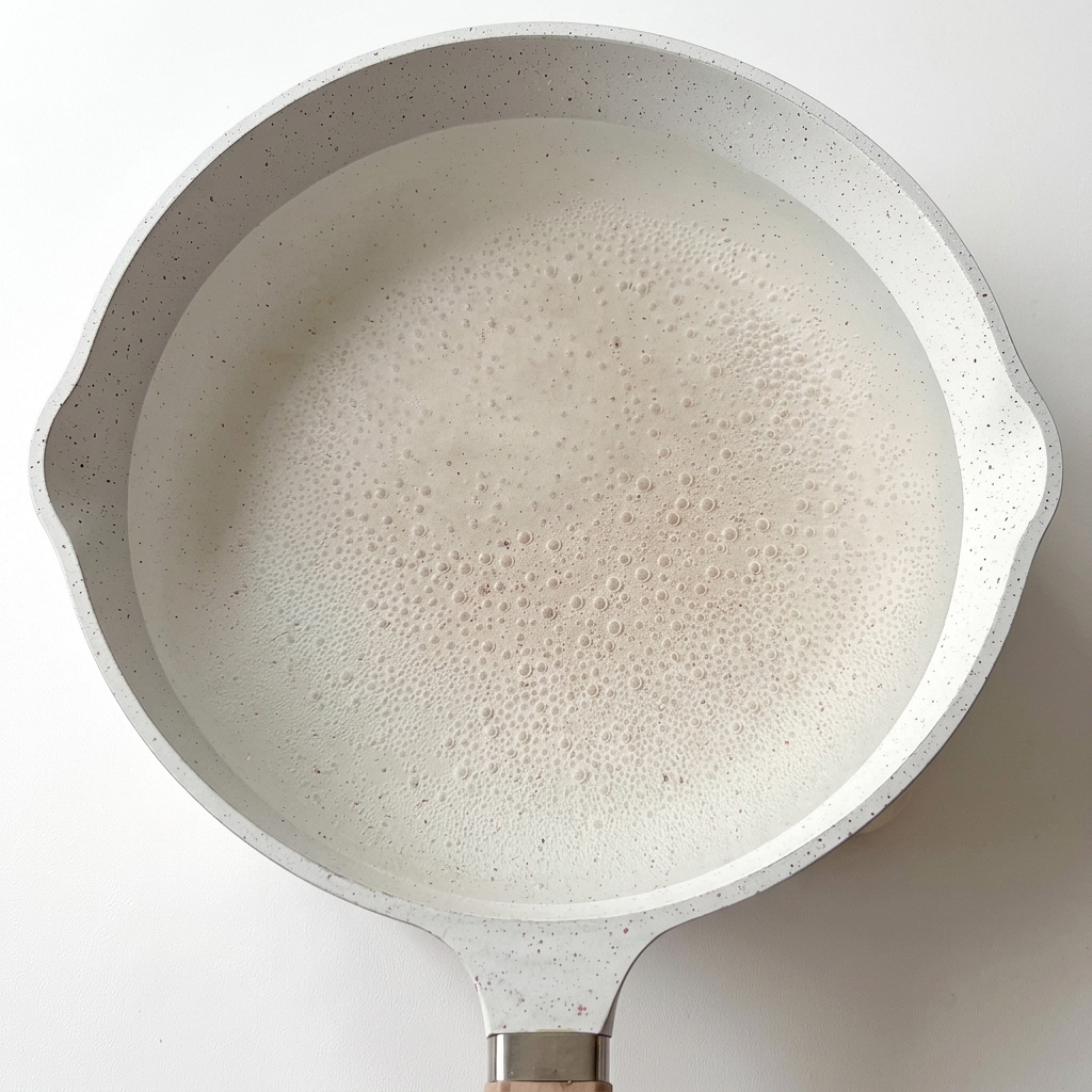 Fusilli pasta cooking in a large pot of boiling water.