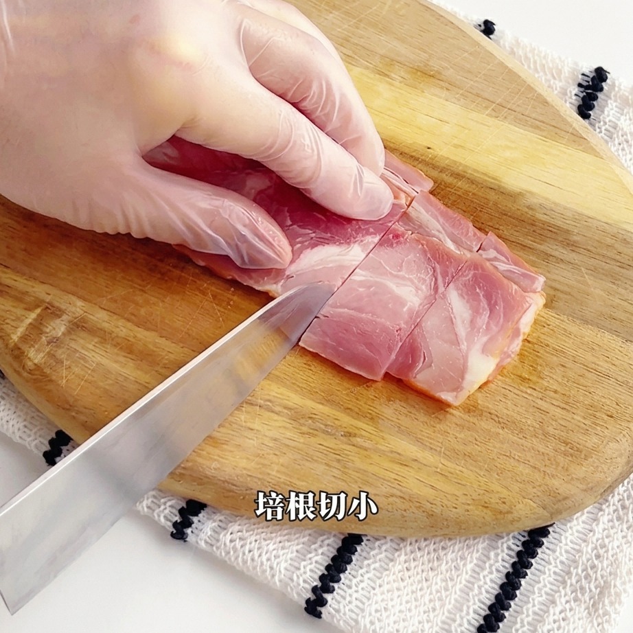 Fresh asparagus stalks being chopped into smaller segments on a cutting board.