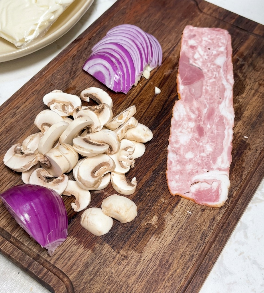 Bacon strips cut into neat rectangular pieces arranged on a wooden board.
