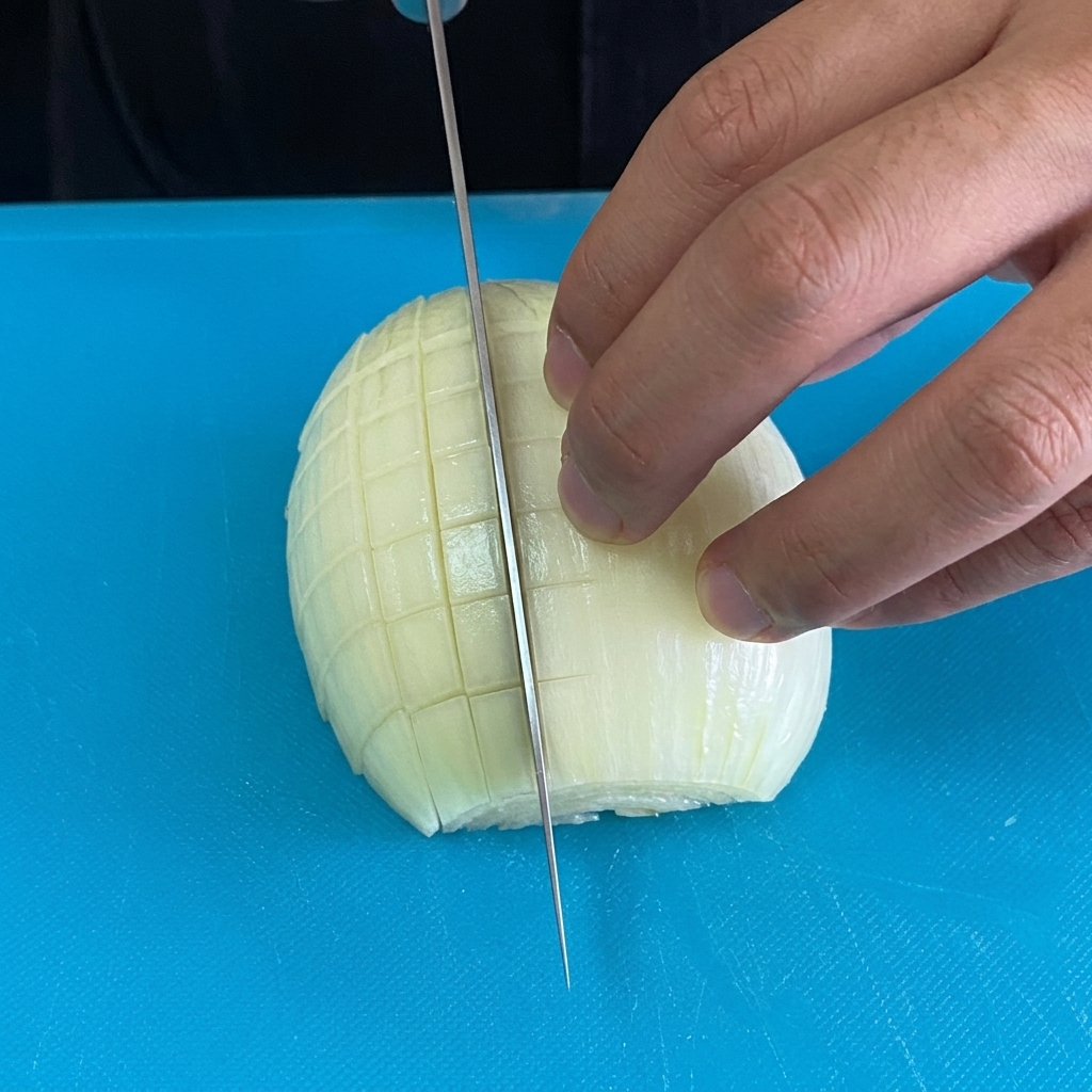 Finely diced onion pieces on a blue cutting board.