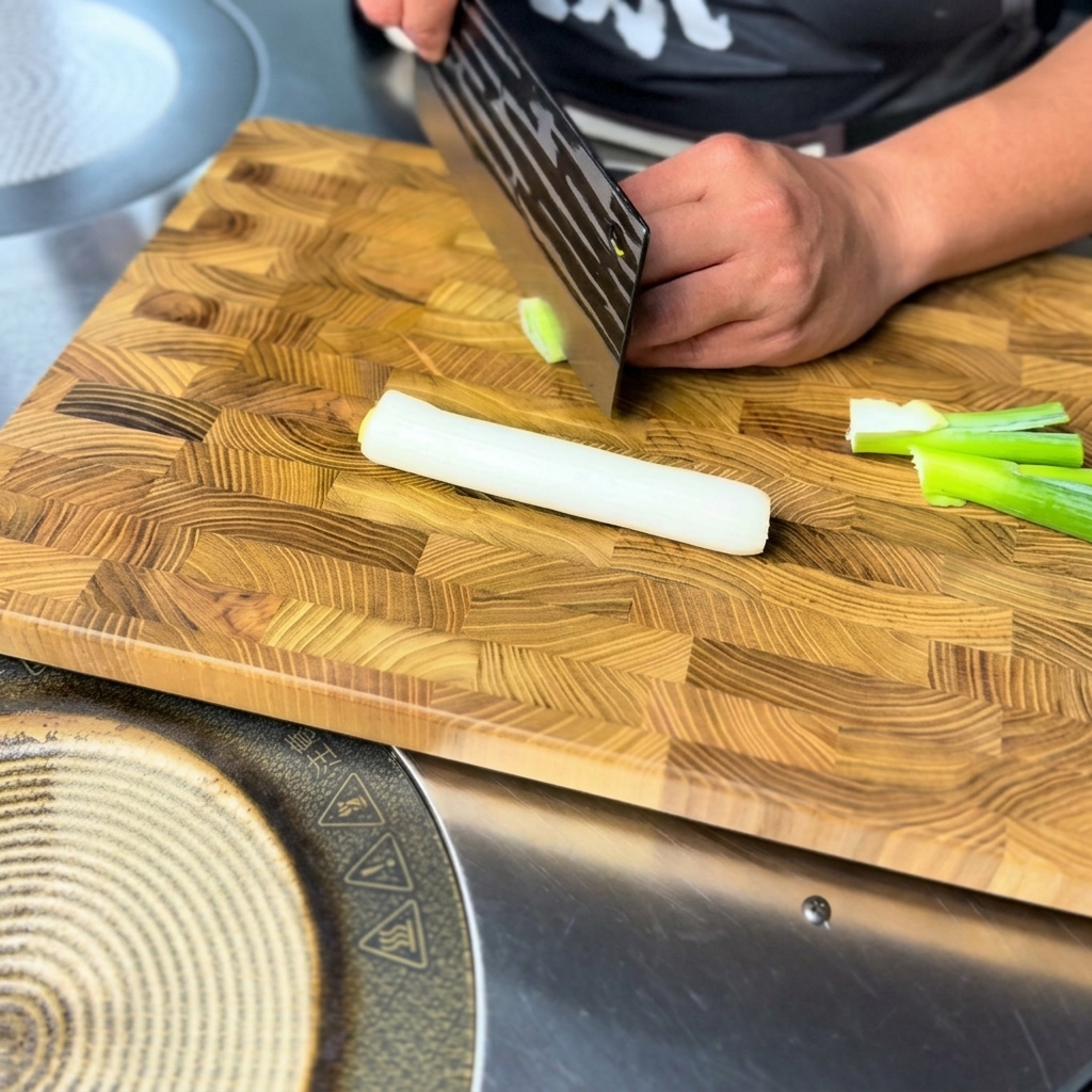 Finely chopped fresh green onion pieces ready for use on a wooden cutting board.