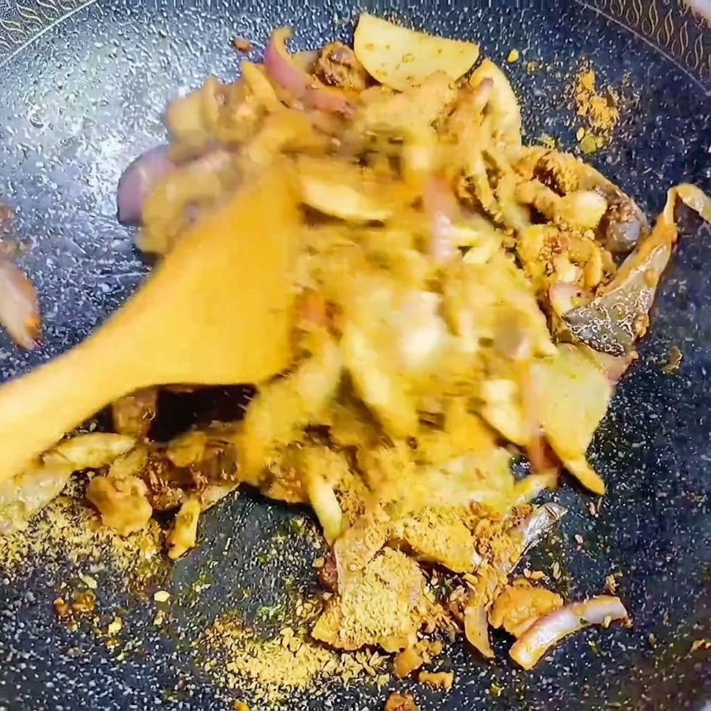 Mushrooms and onions being tossed in a pan with Korean BBQ seasoning.