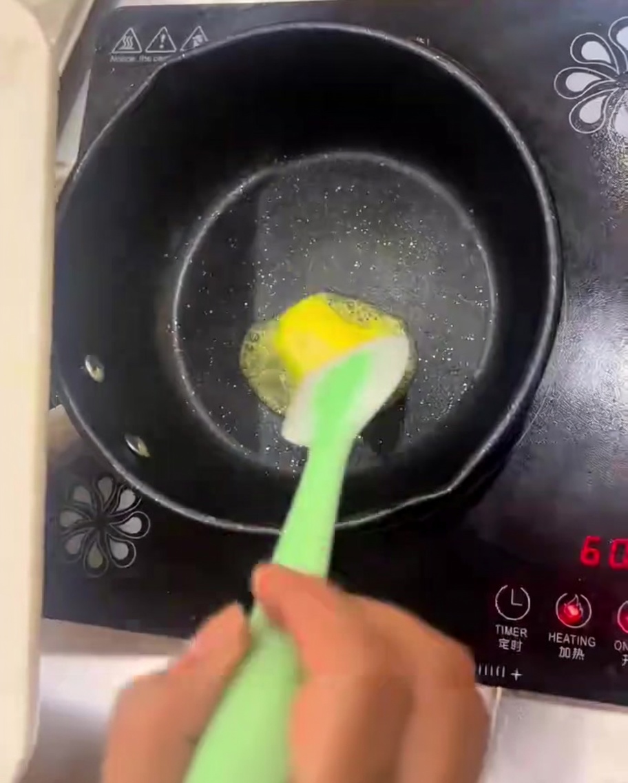 Butter melting in a pan with onions and mushrooms being sautéed.