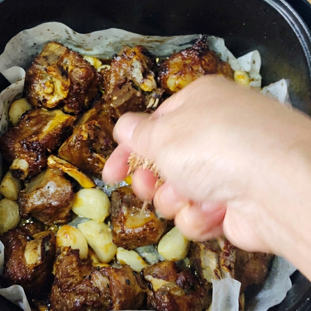 Golden-brown roasted pork ribs garnished with a sprinkle of toasted sesame seeds and fresh chopped green onions.