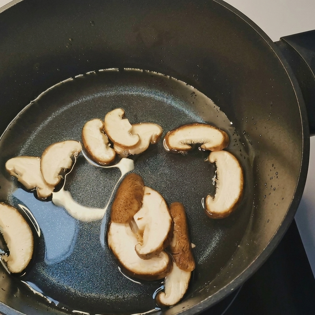 A pot of boiling water with sliced mushrooms, bean sprouts, and corn being added.