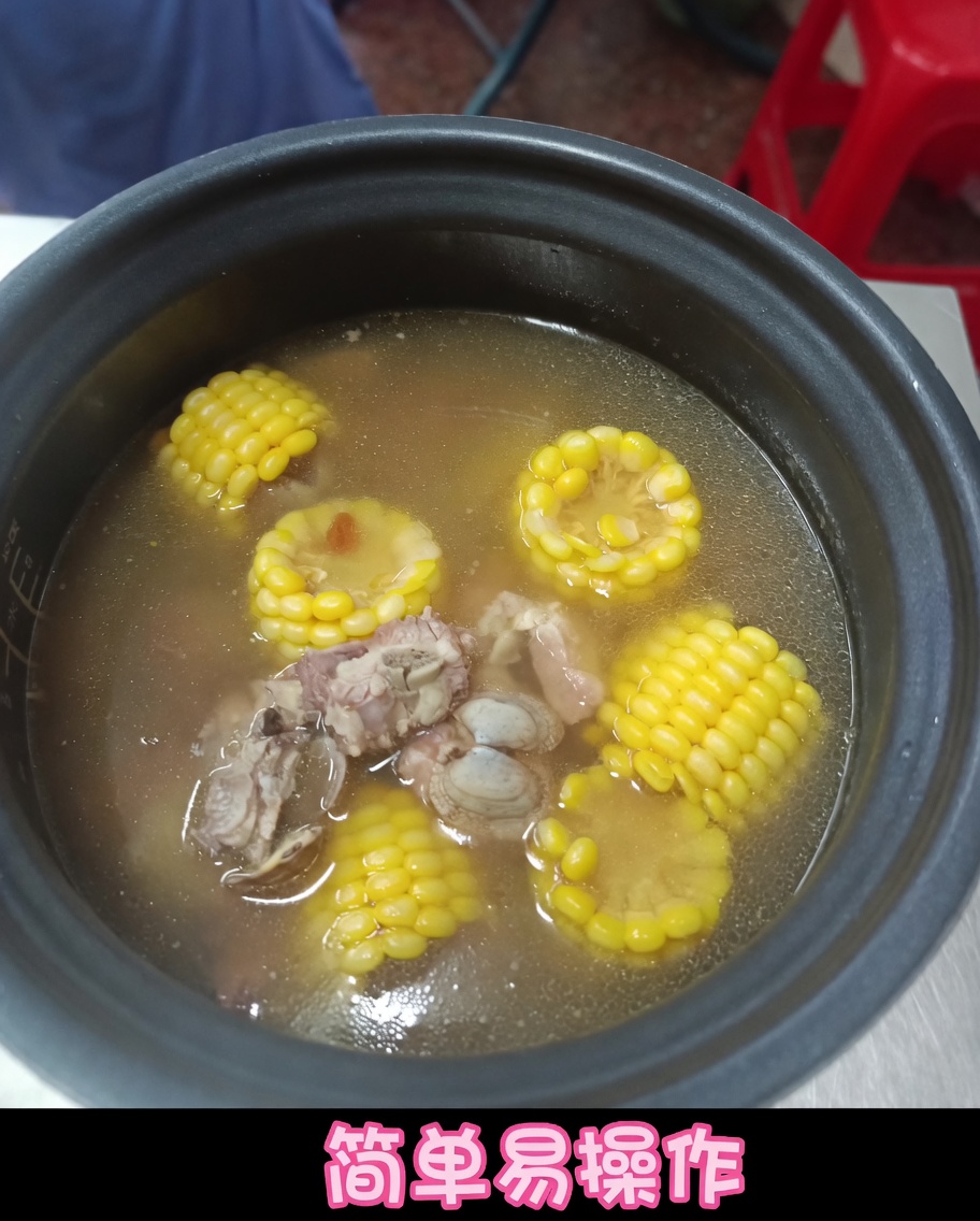 Blanched clams being dropped into the pressure cooker pot alongside ribs, corn, and broth.
