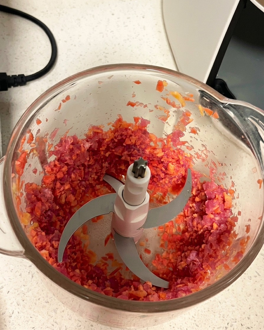 Minced pork and carrot mixture with a uniform texture inside the blender container.