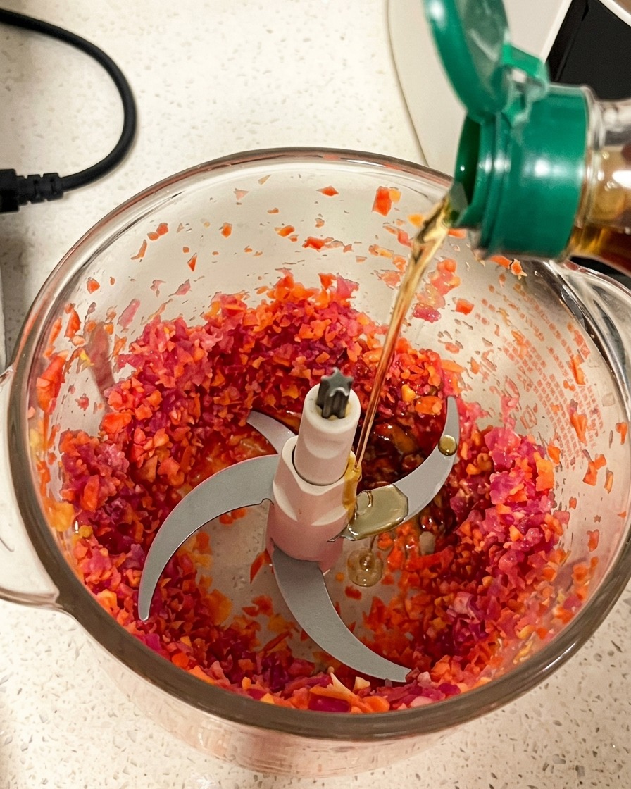 Minced pork filling in a blender container with various sauces being poured in for seasoning.