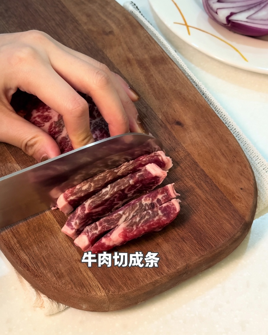 A close-up view of raw beef being sliced into strips on a wooden cutting board.