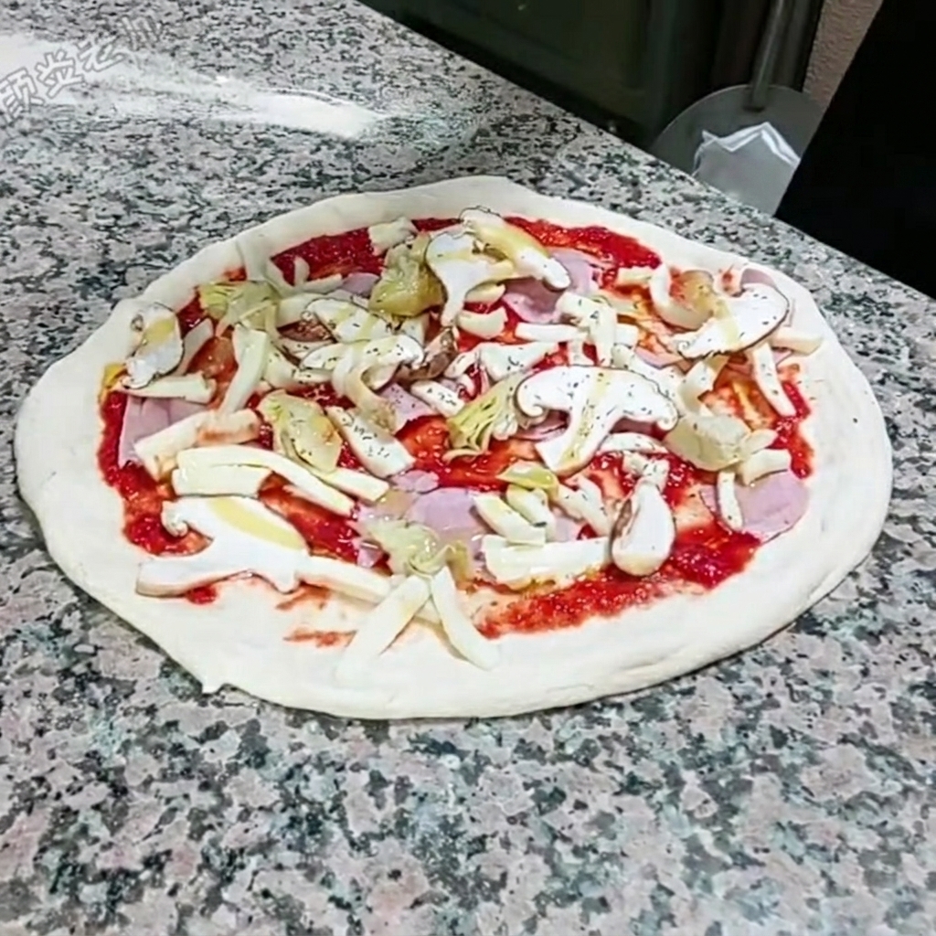 Dried oregano being sprinkled by hand over the assembled pizza.