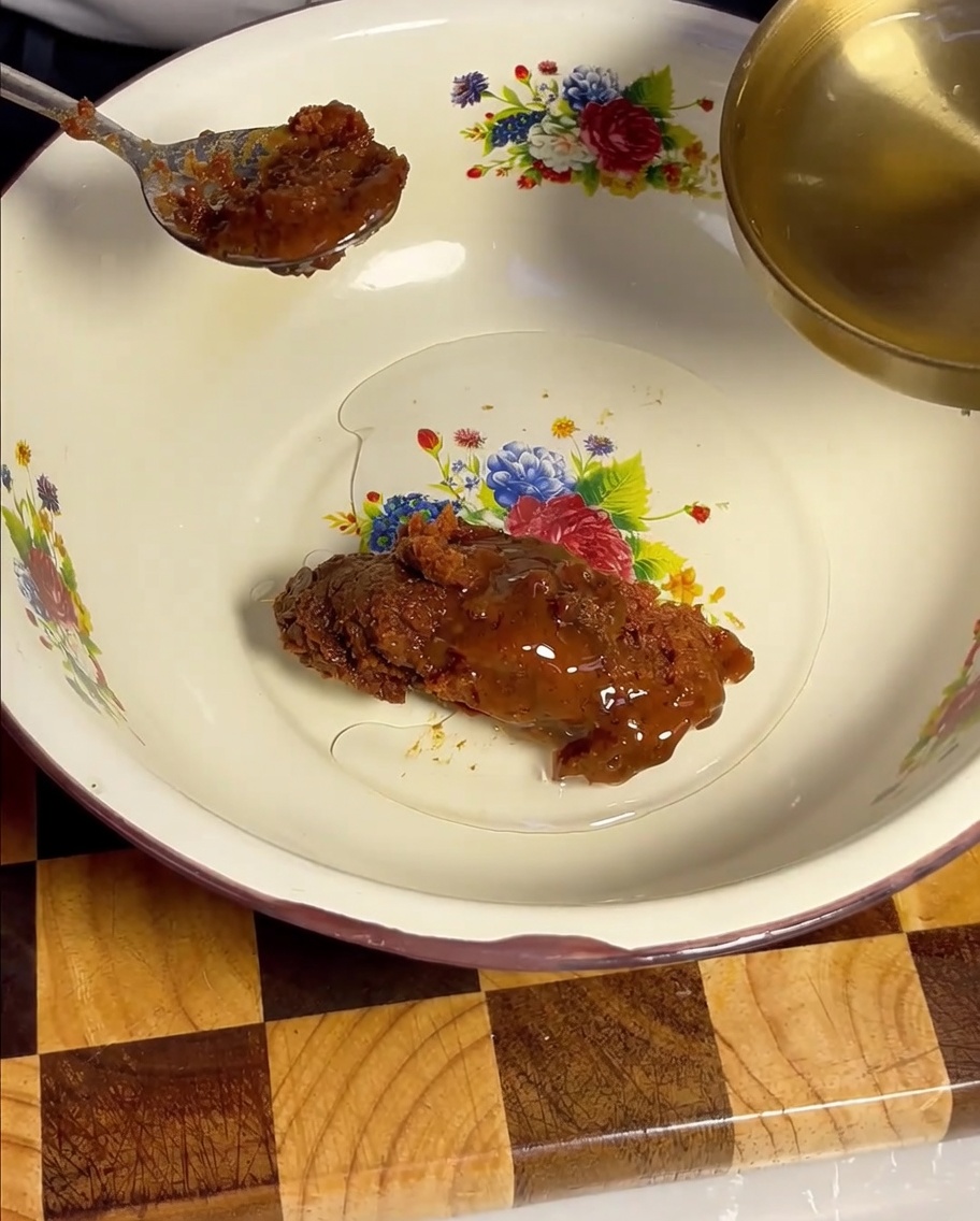 Clear cooking wine being poured from a golden ladle into the mixing bowl with soybean paste.