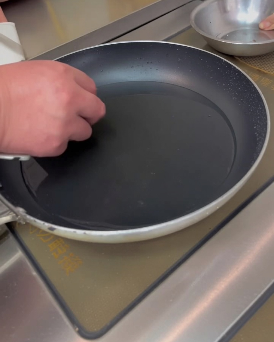 Rice cakes boiling in water in a pan.