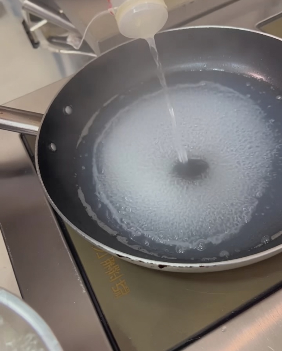 Squid rings being blanched in boiling water.
