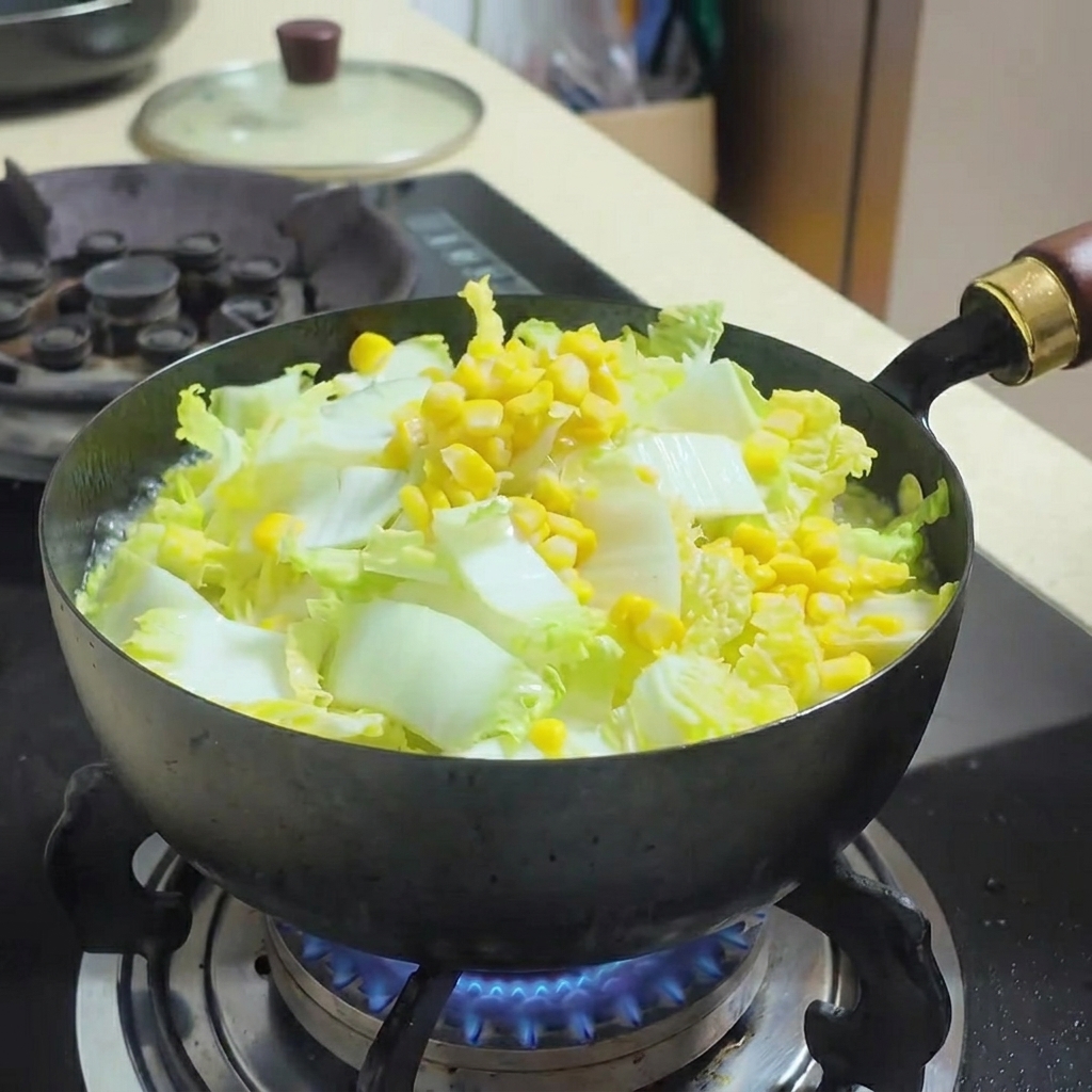 Water-packed tuna being stirred into the vegetable and tofu soup.