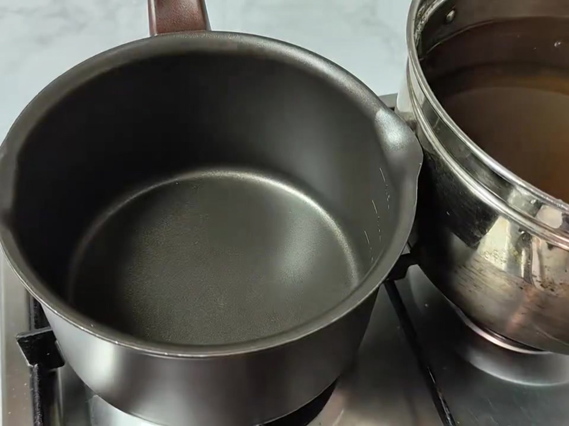 Ingredients including radish greens, tofu, potatoes, onions, and enoki mushrooms arranged in a cooking pot.