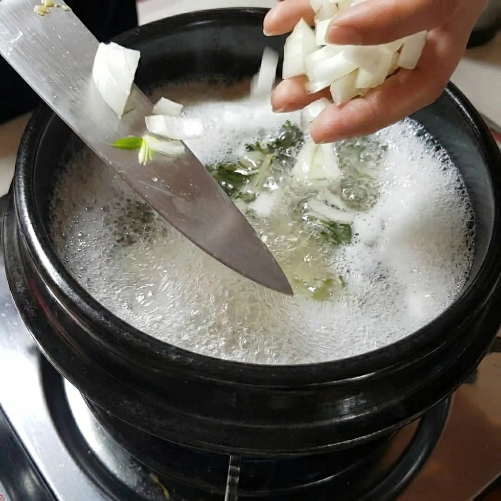 Hands adding sliced onions and mushrooms into the simmering soup pot.