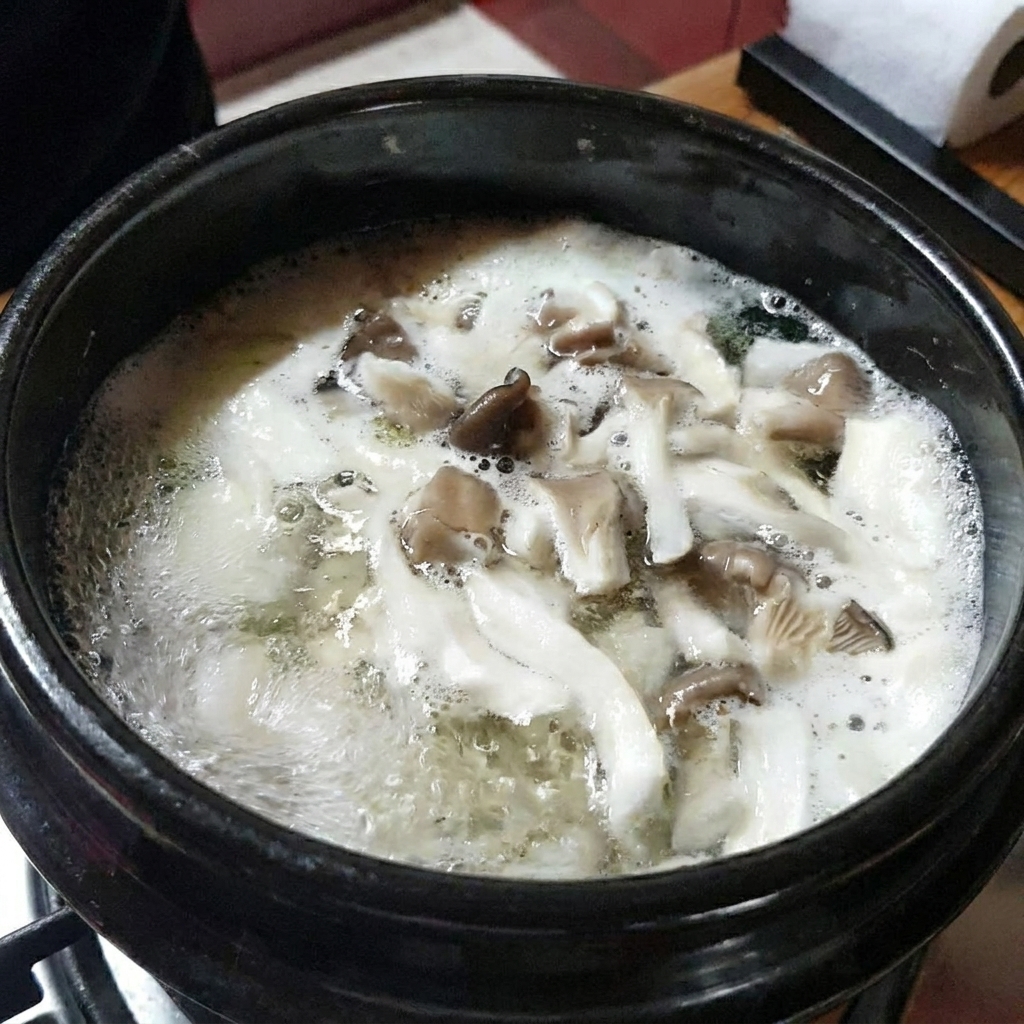 A close-up shot of sliced zucchini being added to the boiling stew.