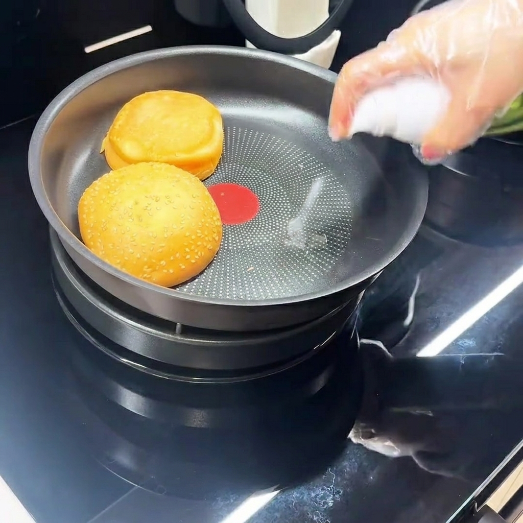An egg frying in a black non-stick pan.