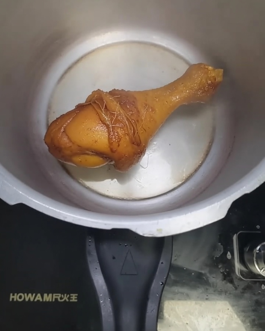 Minced sand ginger and garlic frying in hot oil within the pressure cooker.