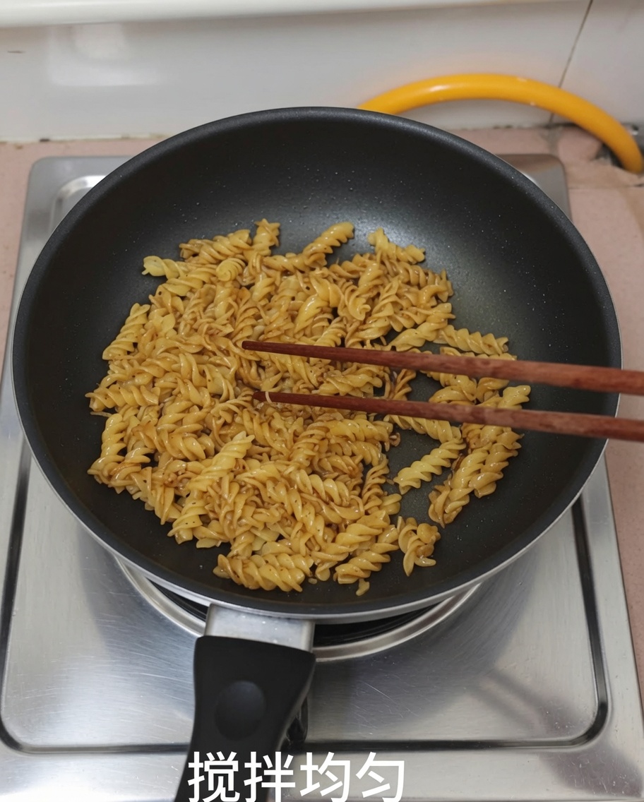 Pasta and black pepper sauce being mixed in a pan using chopsticks.