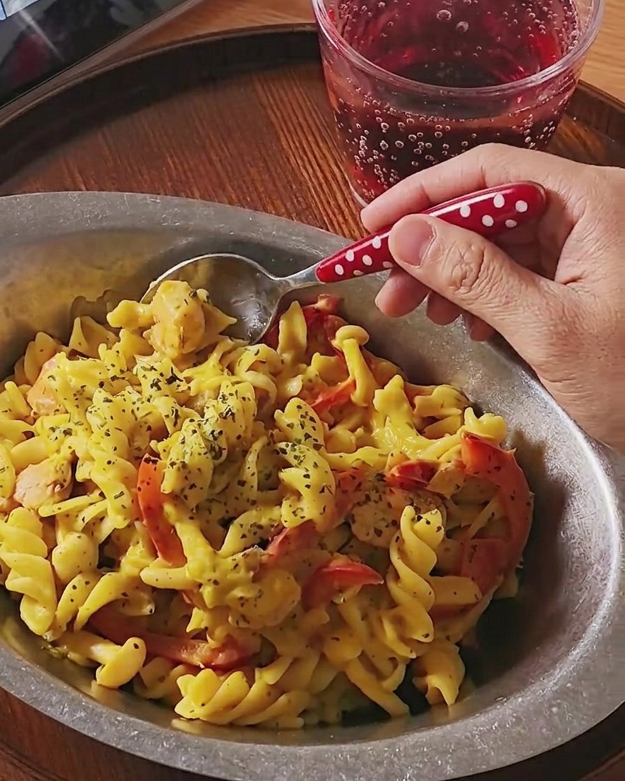 Fusilli pasta cooking in a pot of boiling water.