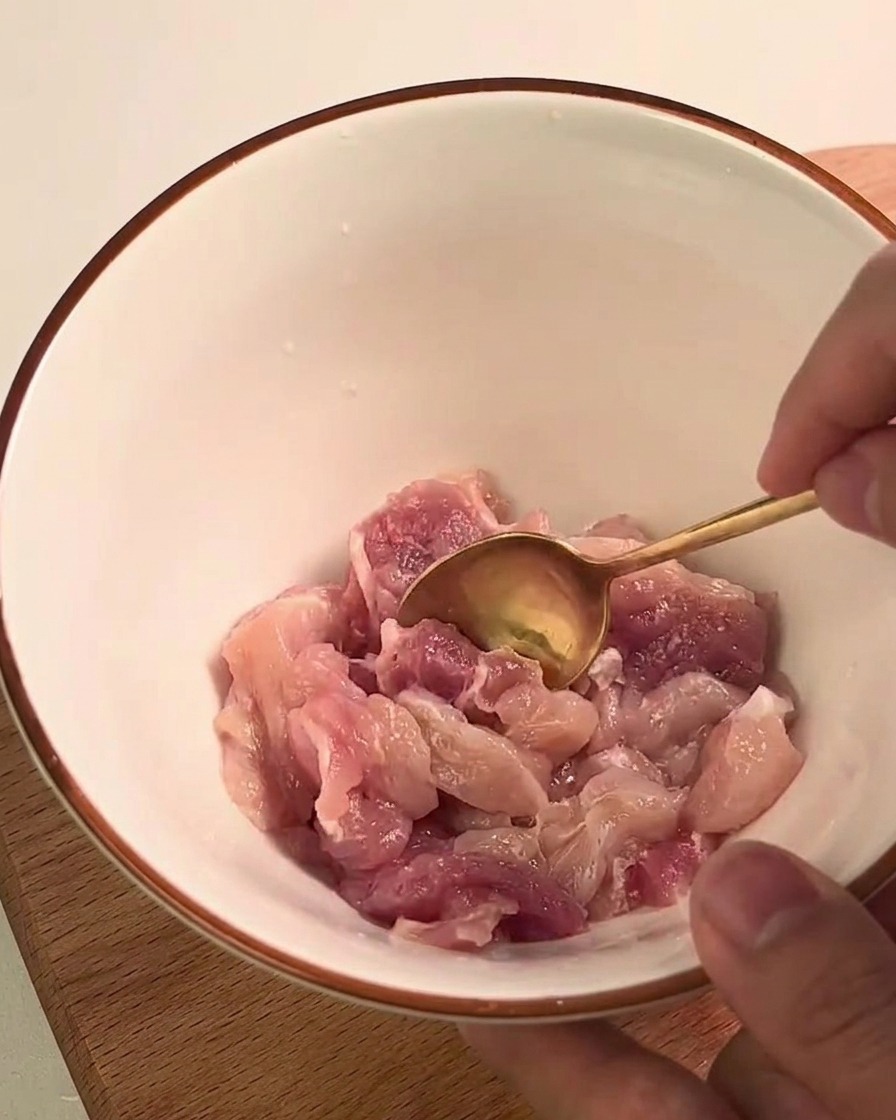 Cooked kabocha squash being mashed with a fork inside a glass measuring cup.