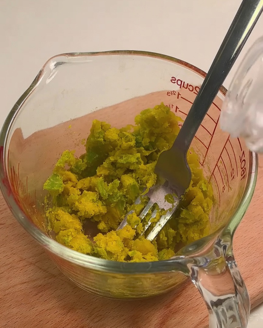 Milk being added to mashed squash to create a creamy sauce base.