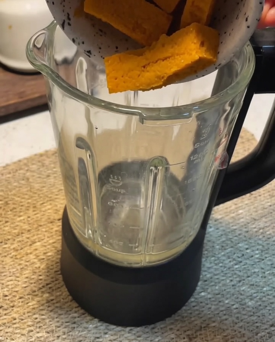 Blender filled with smooth, orange pumpkin sauce.