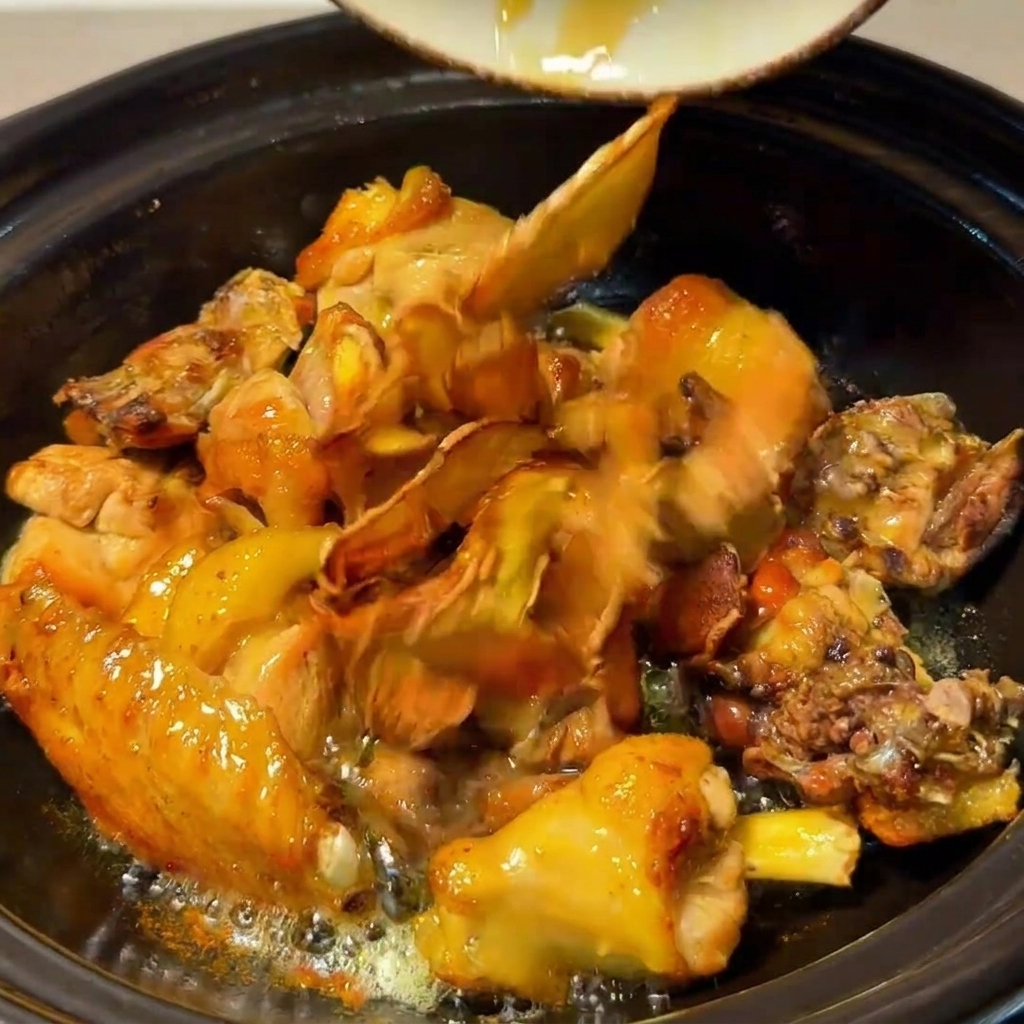 Chicken, mushrooms, fried ginger, and red dates simmering together in the clay pot.